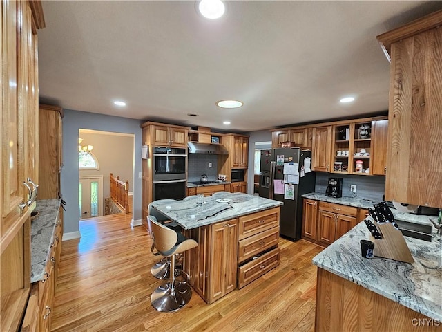 5813 Grace Rd, Deerfield, NY 13502 - kitchen featuring refrigerator with ice dispenser, open shelves, a center island, stainless steel double oven, and light wood-type flooring