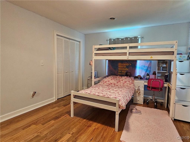 5813 Grace Rd, Deerfield, NY 13502 - bedroom with wood finished floors, an office area, baseboards, and a closet