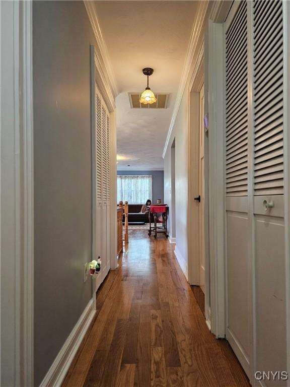 5813 Grace Rd, Deerfield, NY 13502 - hallway featuring crown molding, wood finished floors, and baseboards