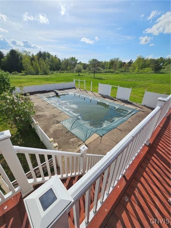 5813 Grace Rd, Deerfield, NY 13502 - view of swimming pool with a covered pool, a lawn, and view of wooded area