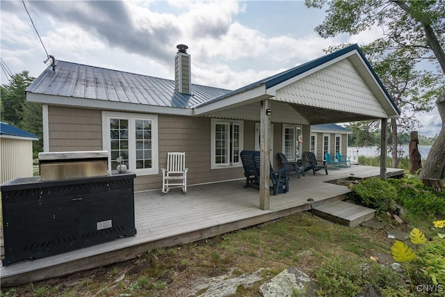 1 Haloah, Hammond, NY 13646 - back of property featuring a chimney, a deck, and metal roof