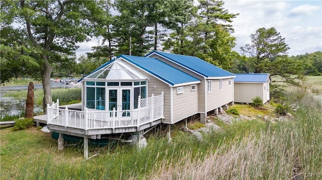 1 Haloah, Hammond, NY 13646 - back of property with a wooden deck and metal roof