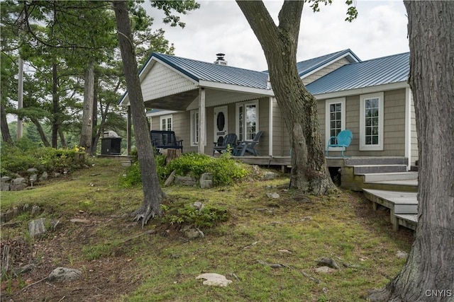 1 Haloah, Hammond, NY 13646 - view of front of home featuring metal roof, a porch, and a chimney