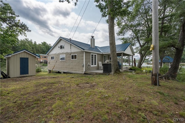 1 Haloah, Hammond, NY 13646 - rear view of property with a shed, a chimney, an outdoor structure, metal roof, and a lawn