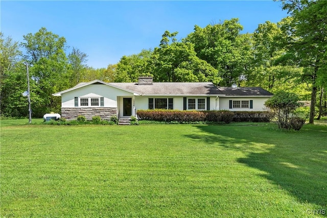 ranch-style home with a front yard and a chimney