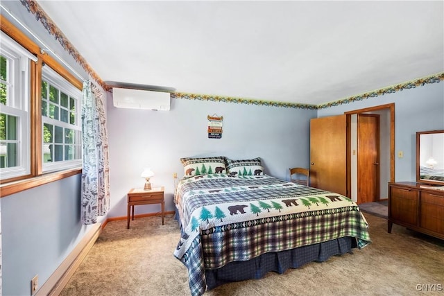 bedroom featuring carpet floors, a wall mounted air conditioner, and baseboards