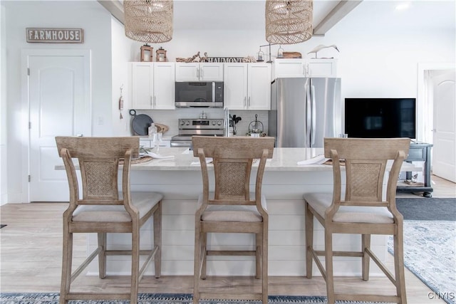26618 Three Mile Point Rd, Lyme, NY 13622 - kitchen featuring appliances with stainless steel finishes, light stone counters, a breakfast bar area, and backsplash