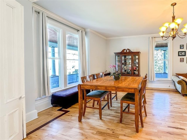442 Front St, Owego, NY 13827 - dining space with a chandelier, light wood finished floors, plenty of natural light, ornamental molding, and baseboards