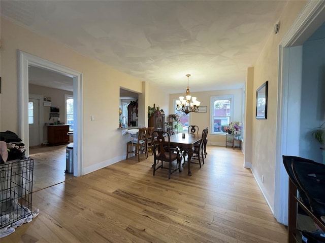 442 Front St, Owego, NY 13827 - dining space with light wood-style flooring, a chandelier, and baseboards
