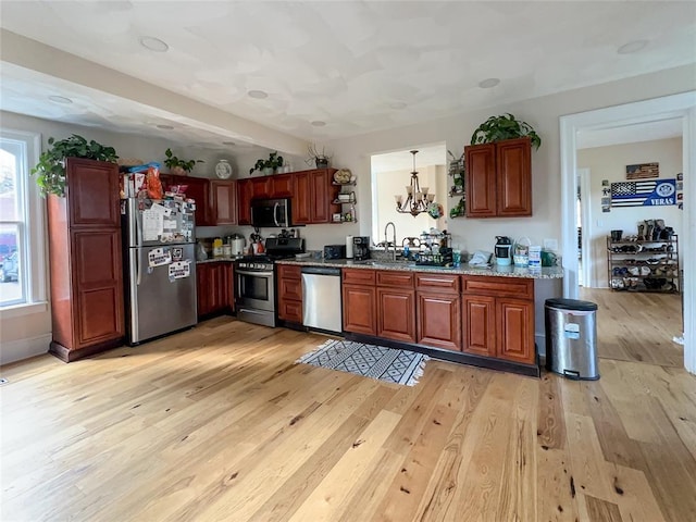 442 Front St, Owego, NY 13827 - kitchen with stainless steel appliances, plenty of natural light, light wood finished floors, and open shelves