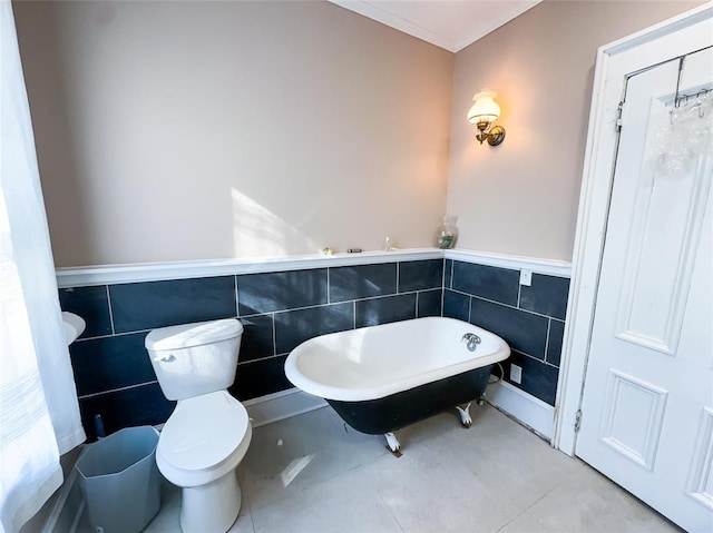 442 Front St, Owego, NY 13827 - bathroom with tile walls, a freestanding bath, a wainscoted wall, toilet, and tile patterned flooring