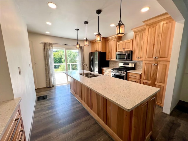 808 Center St, Horseheads, NY 14845 - kitchen featuring appliances with stainless steel finishes, dark wood-type flooring, a center island with sink, decorative backsplash, and recessed lighting