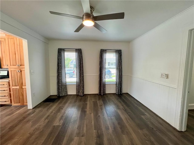 808 Center St, Horseheads, NY 14845 - empty room with a ceiling fan, dark wood finished floors, and wainscoting