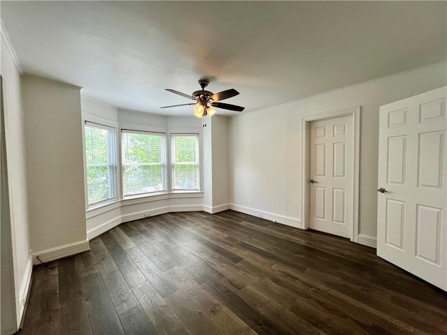 808 Center St, Horseheads, NY 14845 - empty room featuring crown molding, dark wood-style flooring, a ceiling fan, and baseboards