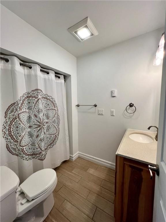 808 Center St, Horseheads, NY 14845 - full bath featuring toilet, wood finished floors, vanity, baseboards, and curtained shower