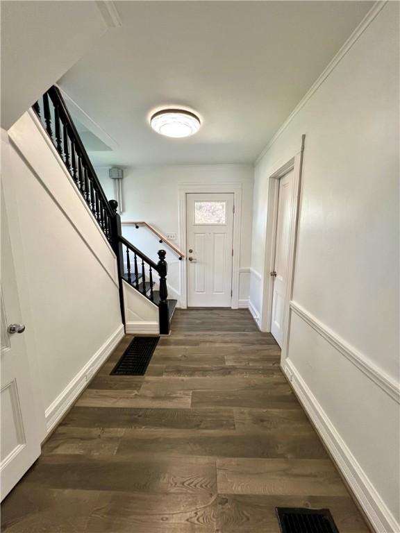 808 Center St, Horseheads, NY 14845 - doorway to outside featuring stairs, dark wood-style floors, and baseboards