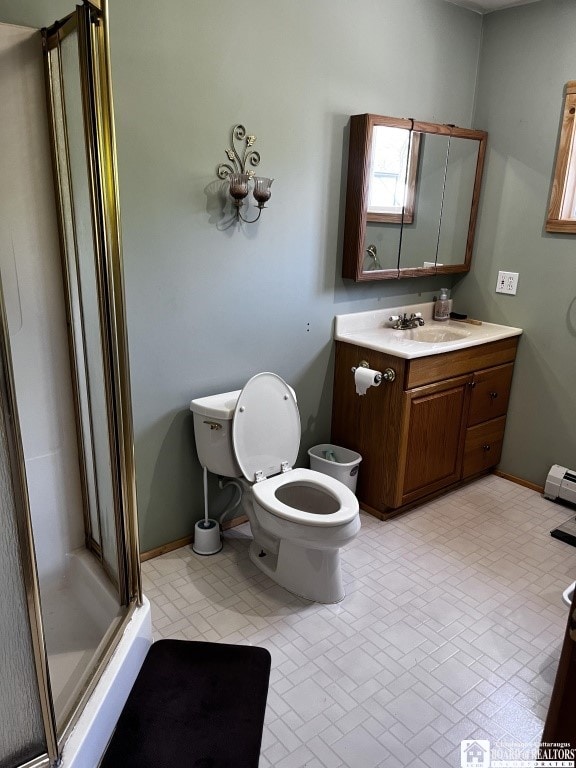 11604 York Rd, Hanover, NY 14136 - full bathroom with a shower stall, vanity, toilet, baseboard heating, and baseboards