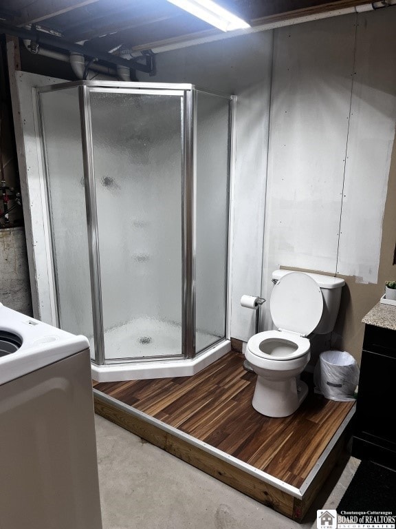 11604 York Rd, Hanover, NY 14136 - bathroom with vanity, concrete floors, a shower stall, and toilet