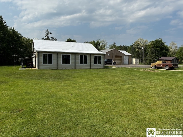 11604 York Rd, Hanover, NY 14136 - rear view of house with a garage, metal roof, and a lawn