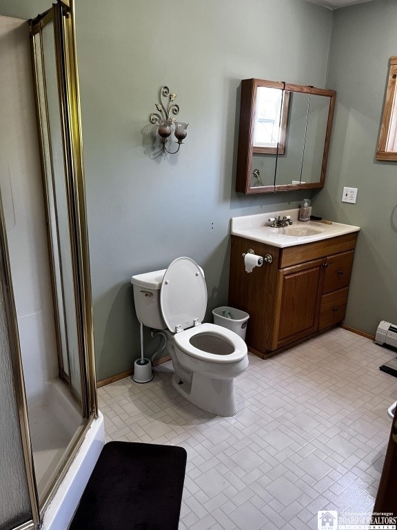 11604 York Rd, Hanover, NY 14136 - full bath featuring a shower stall, vanity, toilet, a baseboard radiator, and baseboards