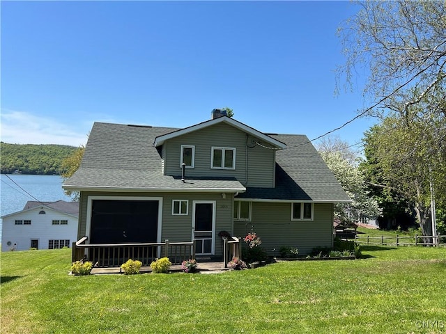rear view of property featuring roof with shingles and a chimney