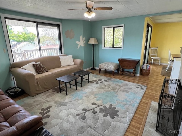 2055 Fitzgerald Pt S, Otisco, NY 13110 - living area featuring wood finished floors, a ceiling fan, and baseboards