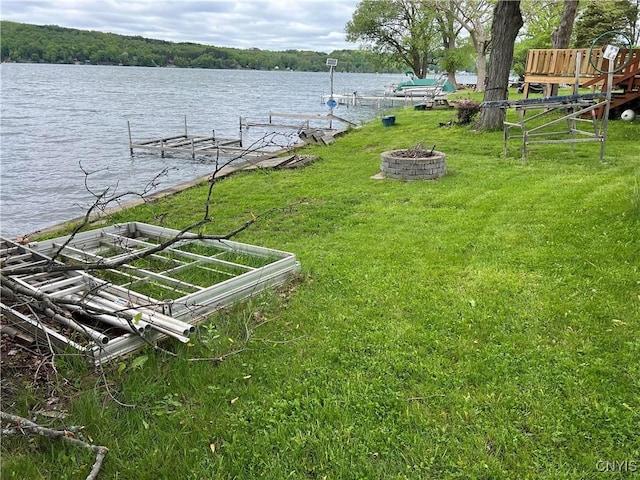 2055 Fitzgerald Pt S, Otisco, NY 13110 - view of grassy yard with a boat dock, a fire pit, and a water view