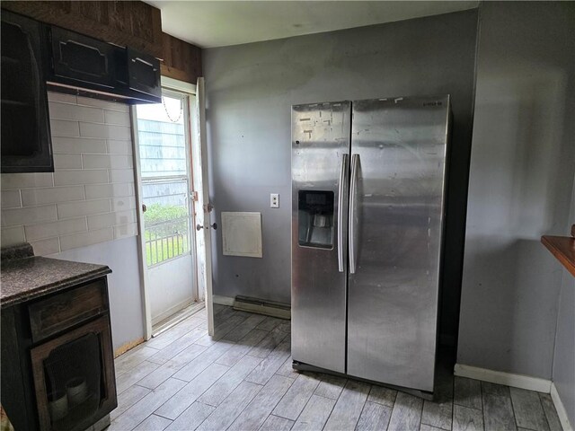 206 Pritchard Ave, Corning City, NY 14830 - kitchen featuring stainless steel fridge, light wood finished floors, baseboards, dark countertops, and dark brown cabinets