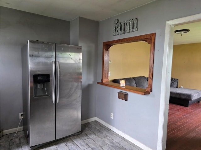206 Pritchard Ave, Corning City, NY 14830 - kitchen with stainless steel fridge with ice dispenser, wood finished floors, and baseboards
