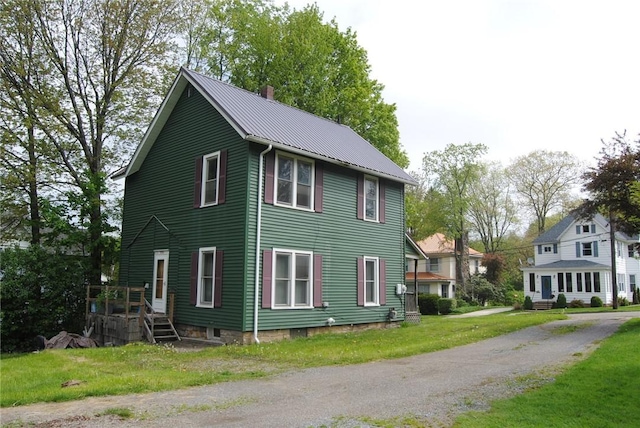 115 Lincoln St, Kane-Borough, PA 16735 - view of side of property featuring a chimney, metal roof, a yard, and a standing seam roof