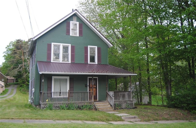 115 Lincoln St, Kane-Borough, PA 16735 - view of front of house featuring a porch, a front lawn, and metal roof