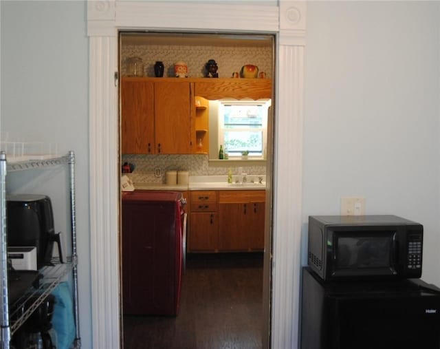 115 Lincoln St, Kane-Borough, PA 16735 - kitchen featuring black microwave, open shelves, dark wood-style flooring, light countertops, and a sink