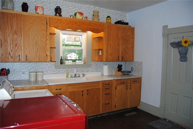 115 Lincoln St, Kane-Borough, PA 16735 - kitchen with decorative backsplash, light countertops, dark wood-type flooring, and brown cabinetry