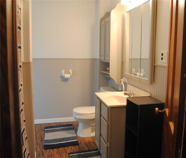 115 Lincoln St, Kane-Borough, PA 16735 - bathroom featuring wainscoting, toilet, wood finished floors, vanity, and baseboards