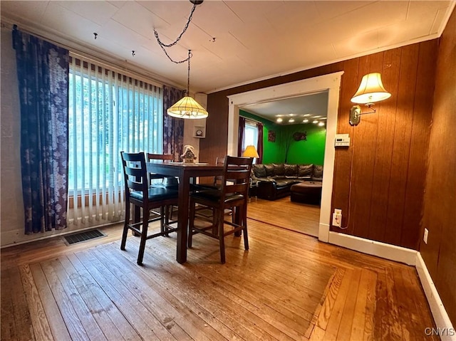 436 Mcgowan Rd, Frankfort, NY 13357 - dining space featuring plenty of natural light, wood-type flooring, and wood walls