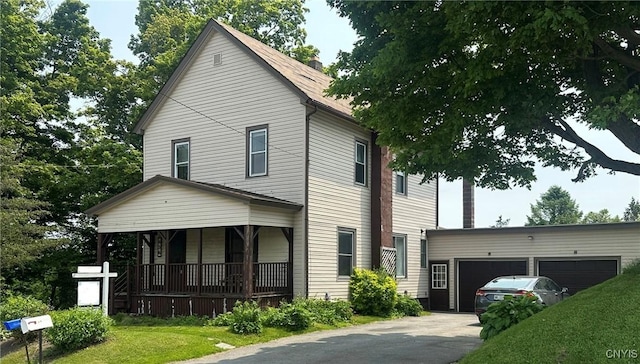 436 Mcgowan Rd, Frankfort, NY 13357 - view of front of property featuring covered porch, asphalt driveway, a garage, and a front lawn