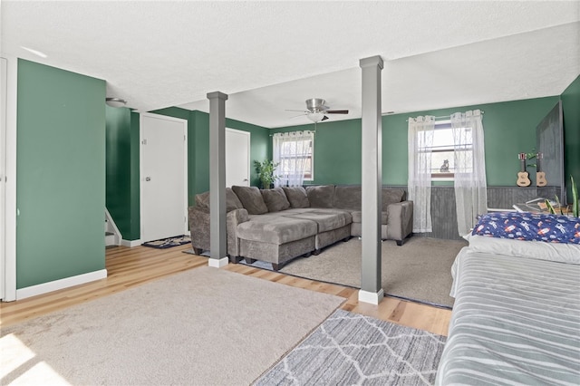 5904 Merrill Rd, Byron, NY 14422 - bedroom with ornate columns, wood finished floors, and a ceiling fan