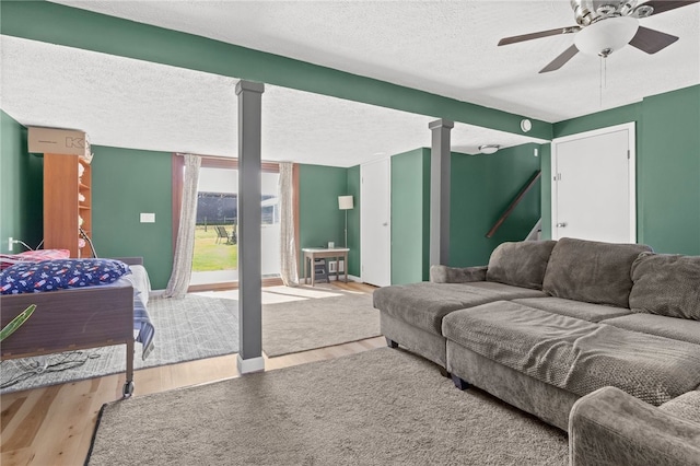 5904 Merrill Rd, Byron, NY 14422 - living area with wood finished floors, a ceiling fan, a textured ceiling, and baseboards