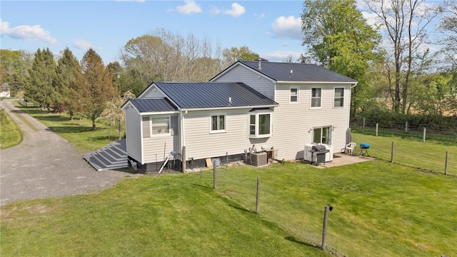 5904 Merrill Rd, Byron, NY 14422 - back of house with central AC unit, metal roof, and a patio area