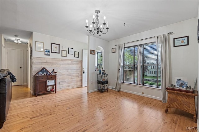 542 Lakeview Dr, Brownville, NY 13615 - dining space with light wood-style floors, a chandelier, baseboards, and arched walkways
