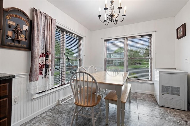 542 Lakeview Dr, Brownville, NY 13615 - dining space featuring a chandelier, healthy amount of natural light, and a wainscoted wall