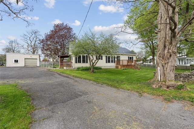 542 Lakeview Dr, Brownville, NY 13615 - view of front facade featuring an outbuilding, asphalt driveway, a front lawn, a deck, and a detached garage