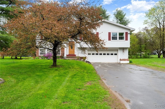 view of front of house with driveway, an attached garage, and a front lawn