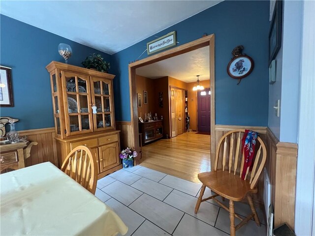 427 Church St, Winfield, NY 13491 - dining space featuring a wainscoted wall and light tile patterned floors