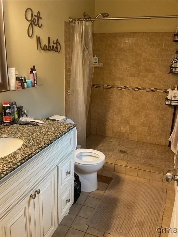 27892 Nys Rte 37, Pamelia, NY 13601 - bathroom featuring a tile shower, tile patterned floors, toilet, and vanity