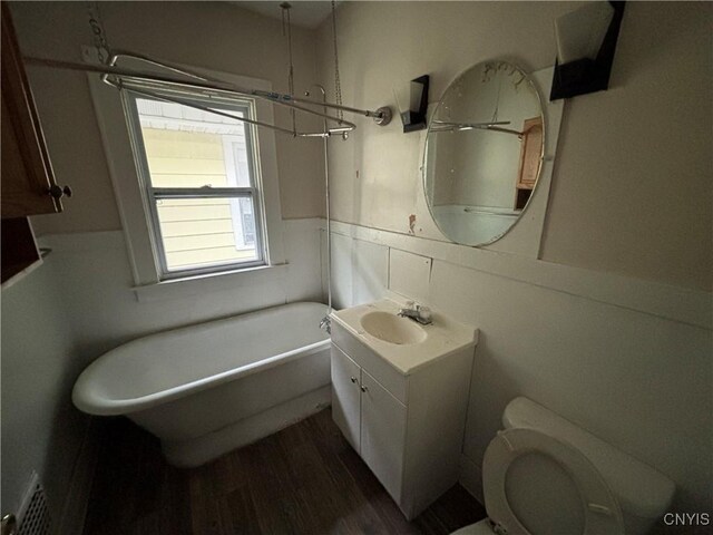 513 Tennyson Ave Unit 15, Syracuse, NY 13204 - full bath with a soaking tub, wainscoting, vanity, toilet, and wood finished floors