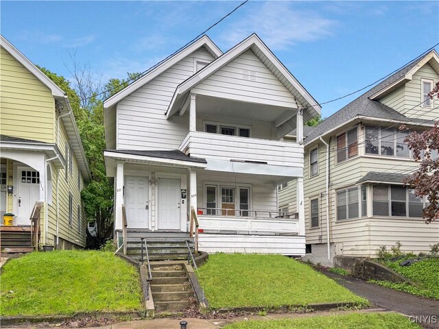 513 Tennyson Ave Unit 15, Syracuse, NY 13204 - view of front facade featuring covered porch, a balcony, and a front yard