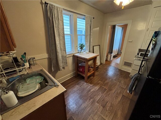 513 Tennyson Ave Unit 15, Syracuse, NY 13204 - kitchen featuring baseboards and dark wood finished floors