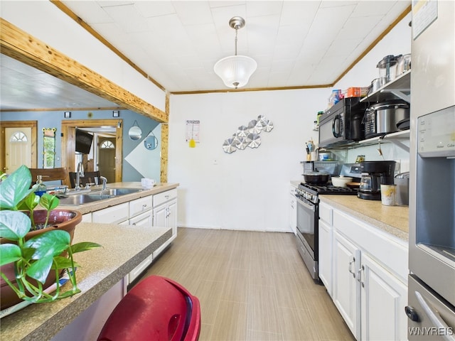 1847 Tuscarora Rd, Niagara, NY 14304 - kitchen featuring appliances with stainless steel finishes, white cabinets, a sink, decorative light fixtures, and light countertops