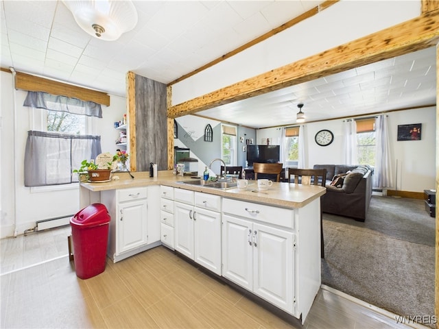 1847 Tuscarora Rd, Niagara, NY 14304 - kitchen with white cabinetry, a peninsula, open floor plan, and light countertops